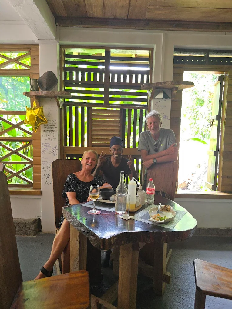 Happy guests at wooden table